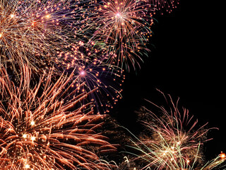 Explosive fireworks display burst in the sky during night time celebration