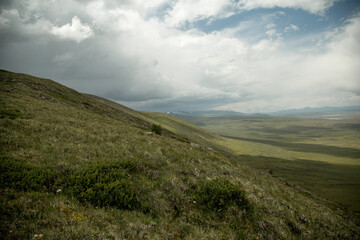 Amazing view of Altai mountain. Background of a steppe at the plateau Ukok. Russian adventures. Mountain hiking in the Altai republic. Active holiday with family and friends. Image with noise effect.