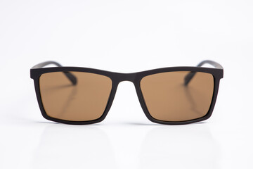 Sunglasses with brown lenses on white isolated background. female or male , fashion