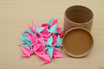 Origami birds with cardboard jar