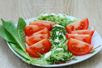 Beautiful salad of tomatoes and cucumber sprinkled with white cheese and herbs
