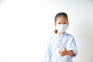Kid girl wearing mask for protect dust pm 2.5, virus and bacteria. Protection from sprayed saliva from patients. Show the left hand as a 