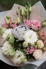 Perfect bouquet of flowers on black table near trees