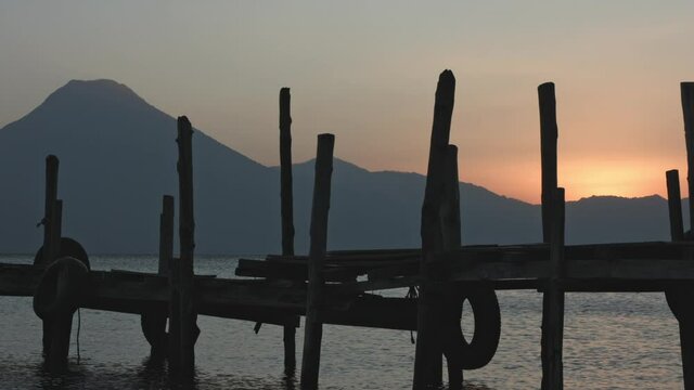 sunset at the atitlan lake pier, with volcano background