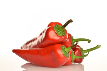 Red organic bell peppers, close-up, on a white background.