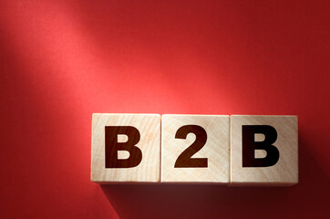 B2B abbreviation on Wooden cubes on red. Business to business concept