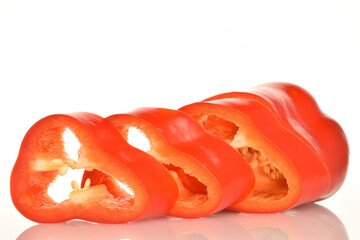 Red organic bell peppers, close-up, on a white background.