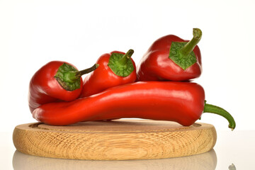 Red organic bell peppers, close-up, on a white background.