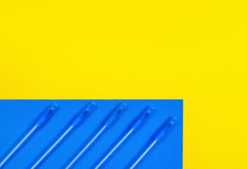 Geometric composition of a bright yellow and blue background with blue pencils. Back to school concept. The horizontal position, lay flat, copy space