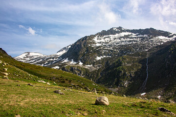 Snowy mountains that begin to melt and become green with spring and around