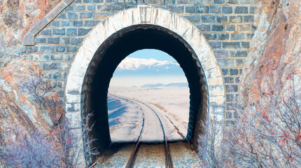 Landscape with railroad  tunnel and road go to the snowy mountain - Dark tunnel in the mountains with snow 