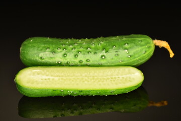 Fresh green cucumbers , close-up, isolated on black.