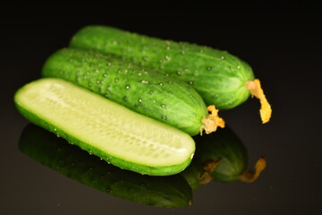 Fresh green cucumbers , close-up, isolated on black.