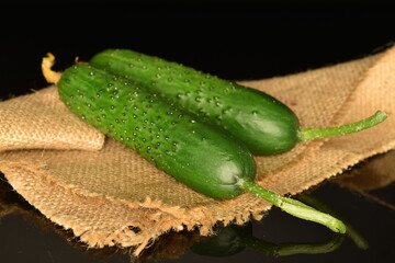 Fresh green cucumbers, close-up, isolated on black.