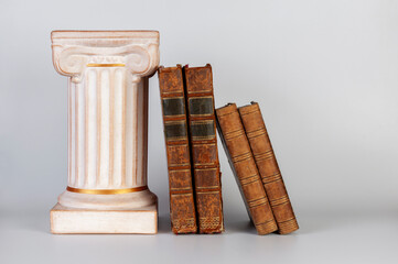 Ancient Greek column and old books. Isolated on white background. No labels, blank spine.