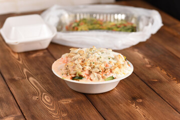 Chicken salad in plastic plate, delivery meal.