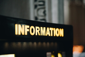 Close up information sign with back light of white and yellow colour