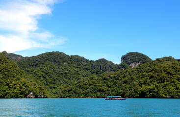 Fototapeta na wymiar landscape view of small Island in sea of with boat and blue sky and water at langkawi (Malaysia)