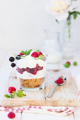 Cheesecake in glass with fresh raspberries, cherry and cream cheese. Healthy homemade organic dessert.