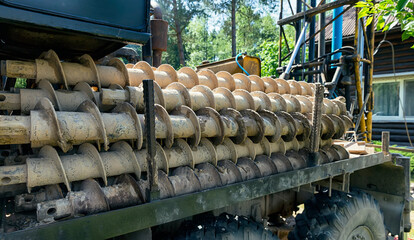 Large drills lie on a machine after drilling a well