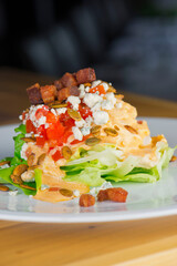 Salad. Classic American or French restaurant salad made w/ kale, Arugula, almonds, blueberries, walnuts, tomatoes, bacon, blue cheese, avocado, tossed w/ olive oil.