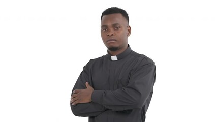 Portrait of confident black priest with folded arms and nodding head standing in half a turn isolated on white background