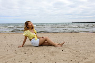Fototapeta na wymiar Beautiful young woman relaxing on the beach in the morning.