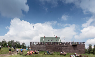 Fototapeta na wymiar Skrzyczne, Poland, July 04, 2020: Peak, with a tourist hostel, meteorological station and telephony tower and chair lift station in Beskid Slaski Mountains