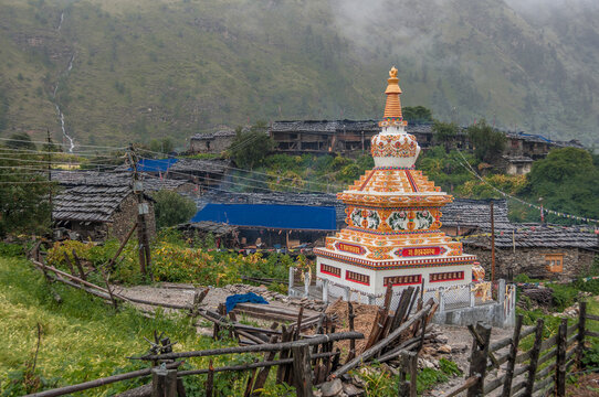 Lho Gaon village, known for its Gompa (monastery) and fine Stupa, on a wet, rainy, cloudy and gloomy afternoon, Manaslu Circuit trek, Gorkha district, Manaslu Himal, Nepal Himalayas, Nepal.