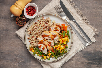 Diet lunch - chicken breast with quinoa and  vegetables on a plate. Top view