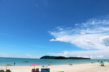 landscape view of pantai cenang beach at Langkawi Island with tourist attraction and background of blue sky and hills