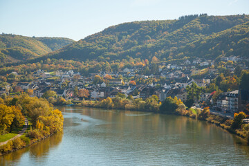 Fototapeta premium Autumn city of Cochem in Germany. October 2018. Many houses on the mountain among the vineyards and the Moselle river.