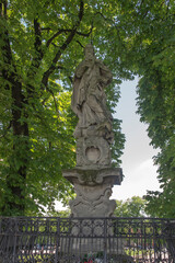 Obraz premium Old statue of St. Prokopa standing on the square in front of the Sanctuary of the Blessed Virgin Mary at Jasna Gora in Częstochowa, Poland