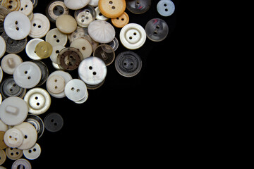 Sewing buttons background. White sewing buttons texture and patterns on black background