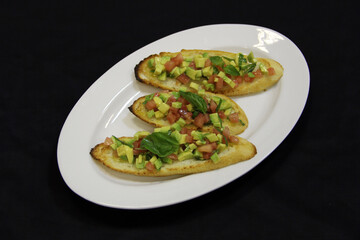 Sandwiches with red fish, basil and avocado on a white plate