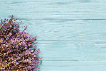 Lavender flowers on blue wooden background, top view, flat lay,copy space
