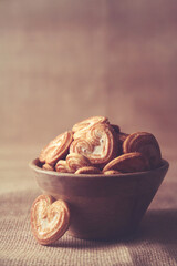 Homemade heart shaped sugar biscuit in wooden bowl