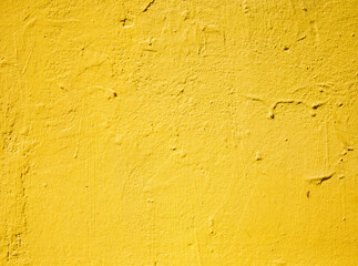Bright yellow painted concrete wall in natural daylight
