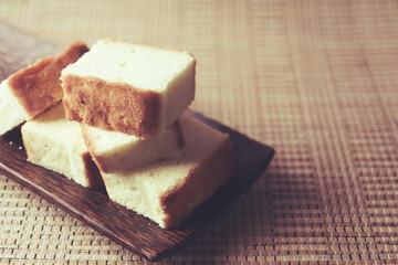 Home made  fresh sponge sliced cakes on wooden tray