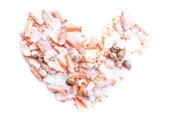 assortment of frozen seafood on ice cubes, shrimps, Babylonia areolata shellfish snails, langoustines, rich in iodine, antioxidants and vitamin, close up