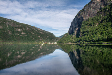 Fototapeta na wymiar Near perfect symmetrical reflection of a mountain in a lake in Norway
