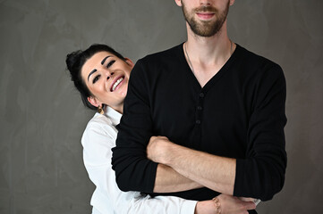 Studio portrait of a caucasian brunette woman and a man in a love relationship with a smile and happiness