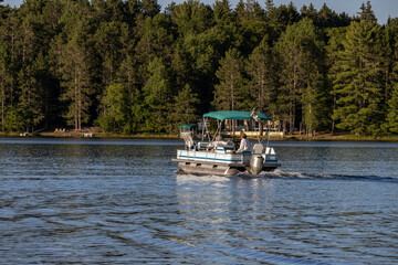 pontoon boat cruising  on lake
