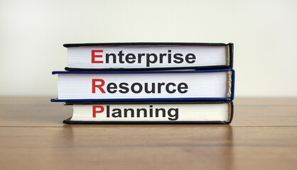 Books with text 'enterprise resource planning' on beautiful wooden table. White background. Business concept.