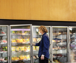supermarket shopping, face mask and gloves,Man choosing frozen food from a supermarket freezer	

