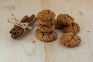 Very tasty peanut butter biscuits on bamboo light brown wooden board, golden baked healthy