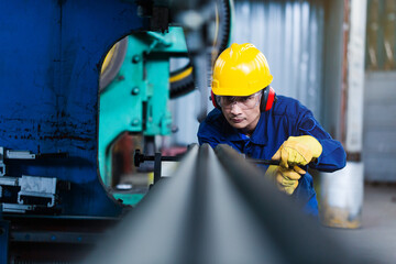 Asian worker using CNC plasma cutter