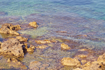 Rocky sea coast of Kolimvari in Crete Greece with turquoise water as a natural background. Copy space.