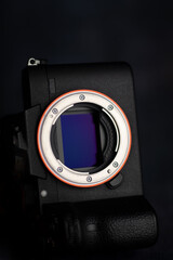 Mirrorless digital camera sensor on a black background. Technology concept