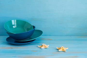 Marine theme table setting on blue wooden background with copy space.